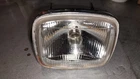 1986 Suzuki LT250EF Quadrunner Headlight Assembly Used. Price: $70.00.